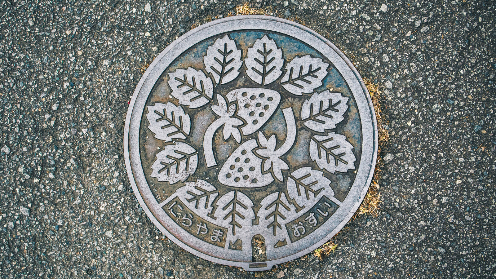 Japanese manhole cover with strawberries and leaves