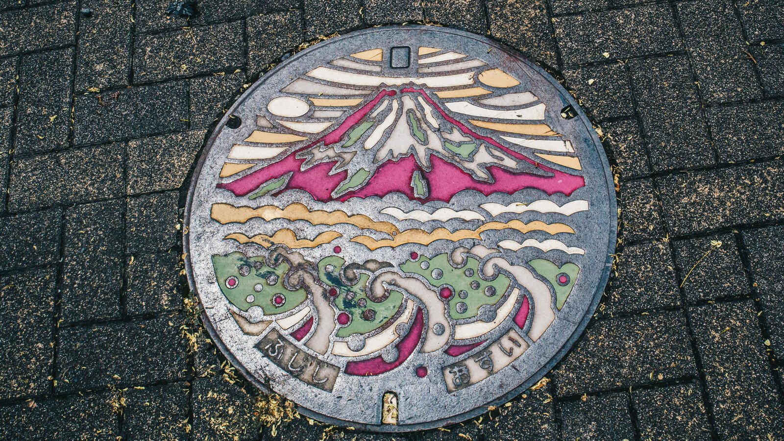 Japanese manhole cover with mountain and sea