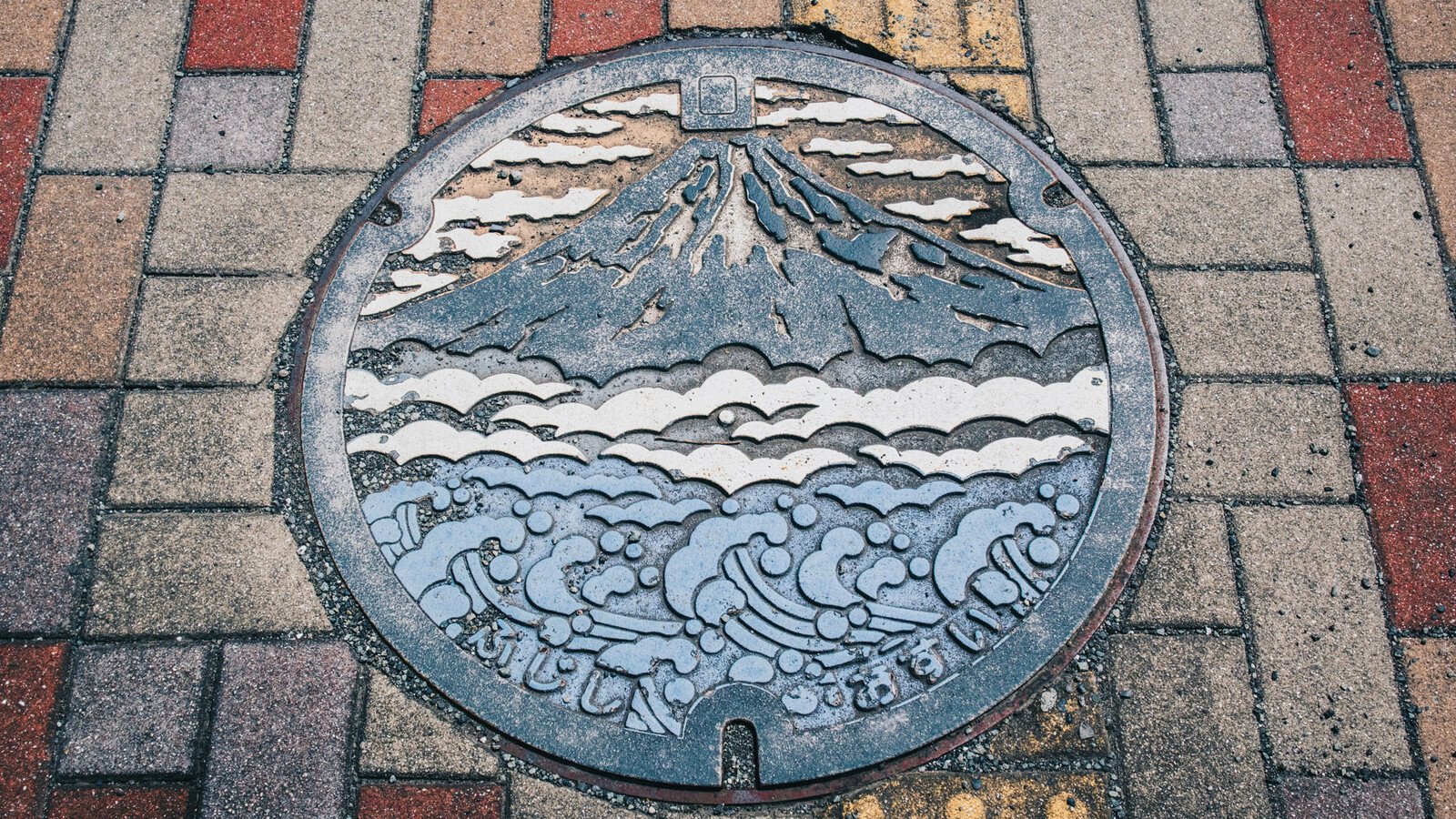 Japanese manhole cover with mountain art