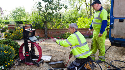 Drainage professionals with jetting equipment unblocking a drain 