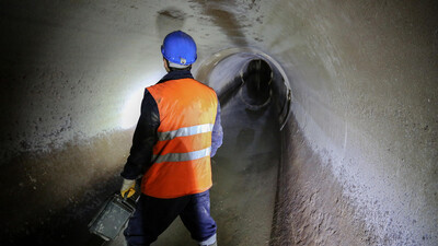worker in sewer pipe underground
